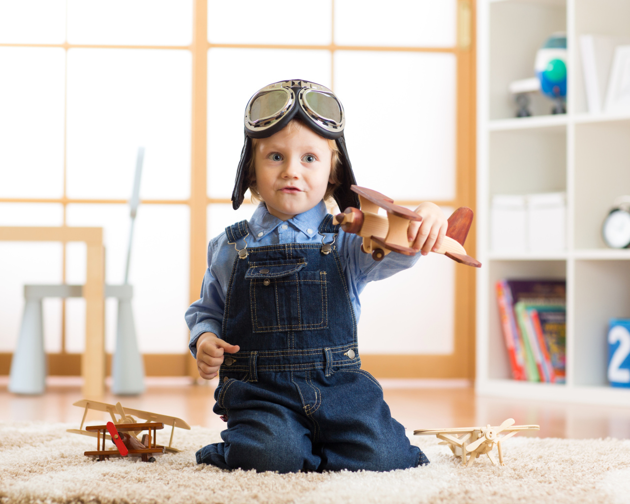Маленький будущий летчик играет с самолетом