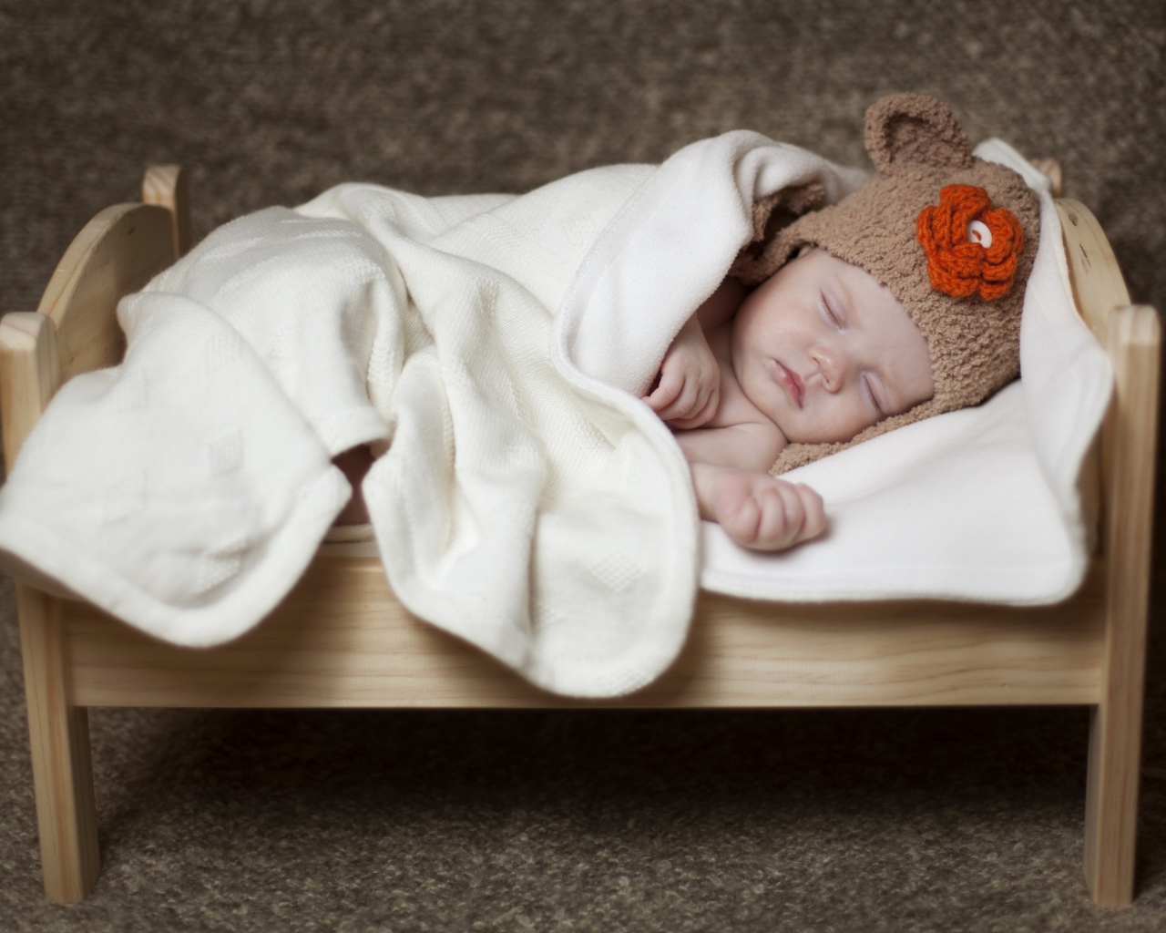 Грудной ребенок спит в маленькой кроватке
