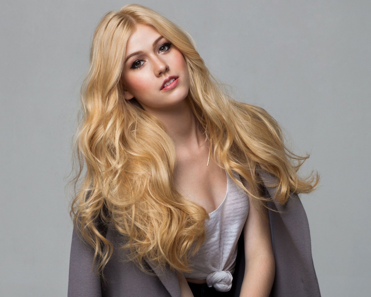 Эффектная блондинка Кэтрин Макнамара на сером фоне