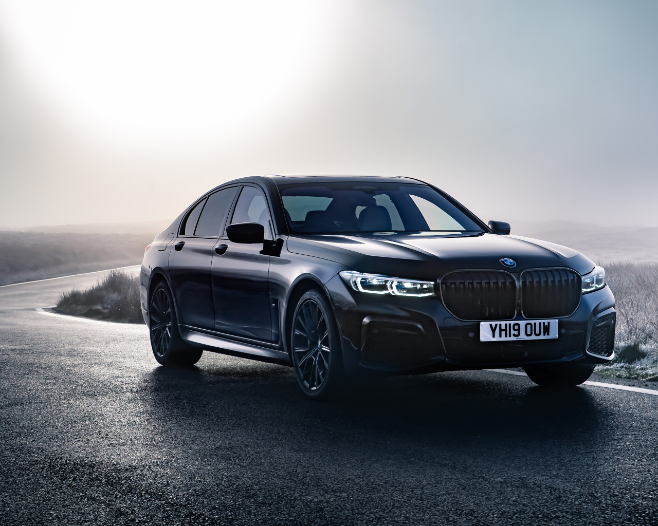 Черный автомобиль BMW 750i xDrive M Sport 2019 года на дороге 