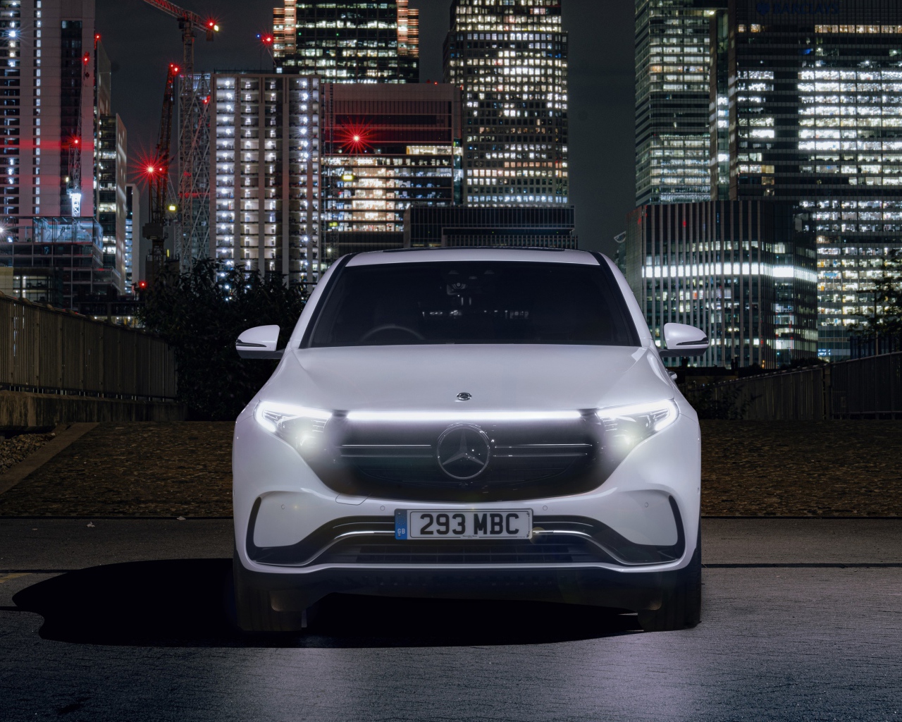 Car Mercedes-Benz EQC 400 4MATIC AMG Line 2019 against the backdrop of skyscrapers