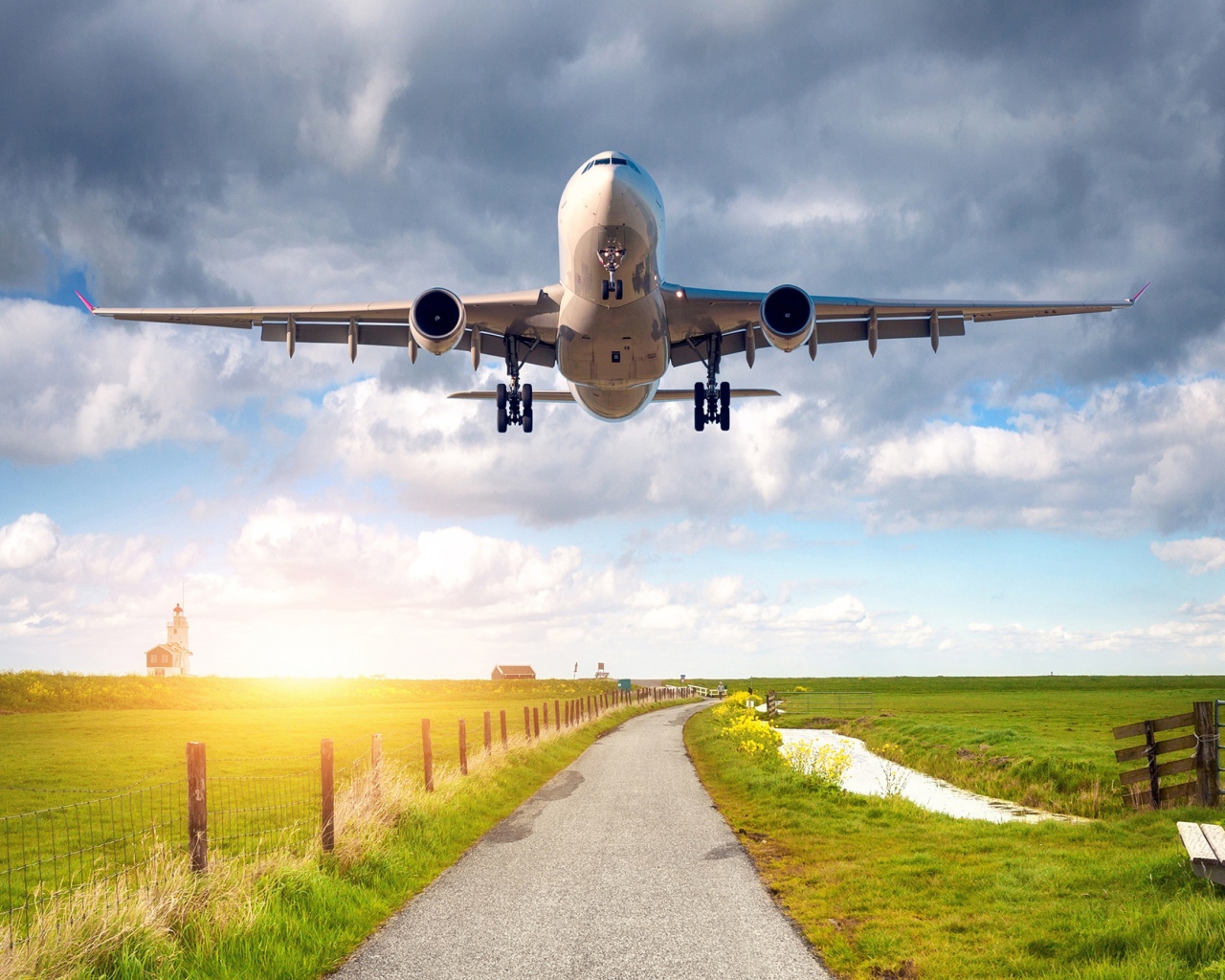 A passenger plane takes off over the field