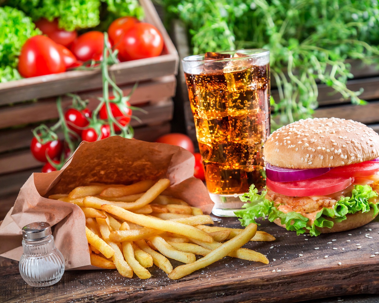 Картофель фри, гамбургер, кола и помидоры на столе