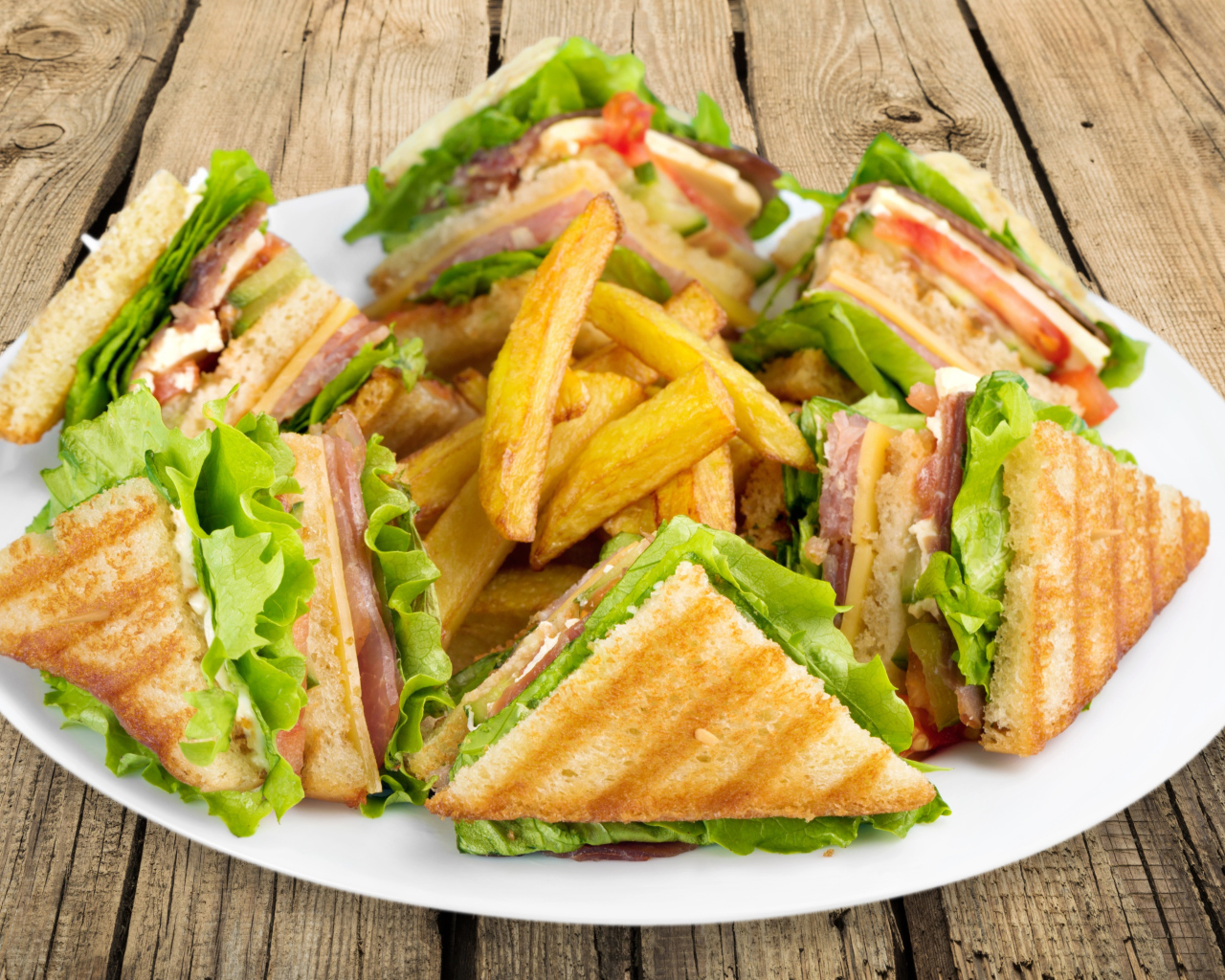 Ham sandwiches on a plate of french fries