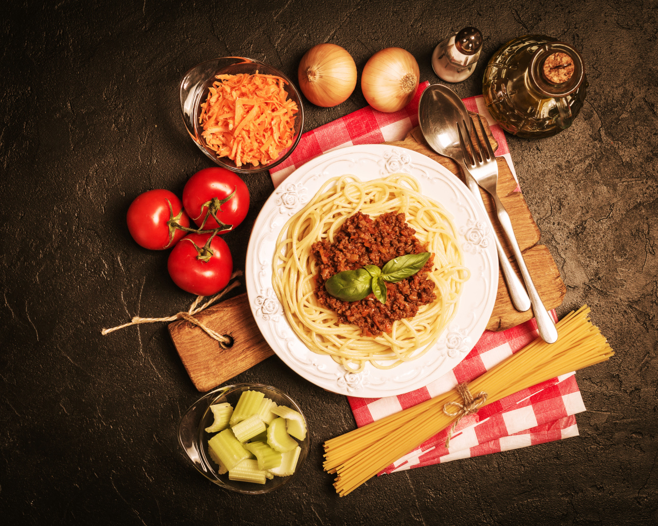 Спагетти с фаршем на столе с овощами