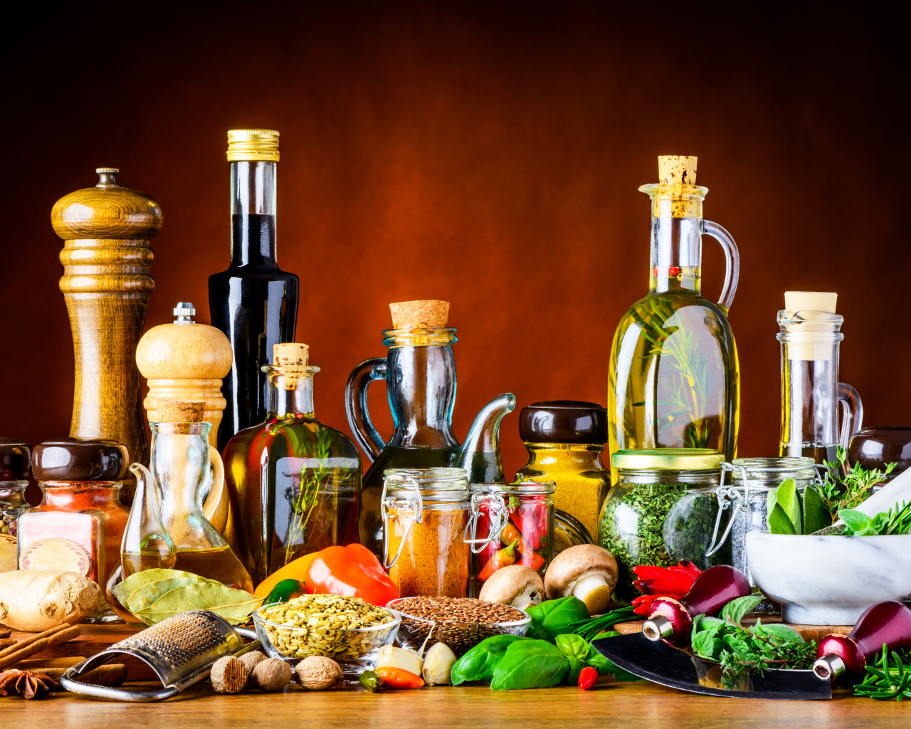 Специи, зелень и масла на столе 
