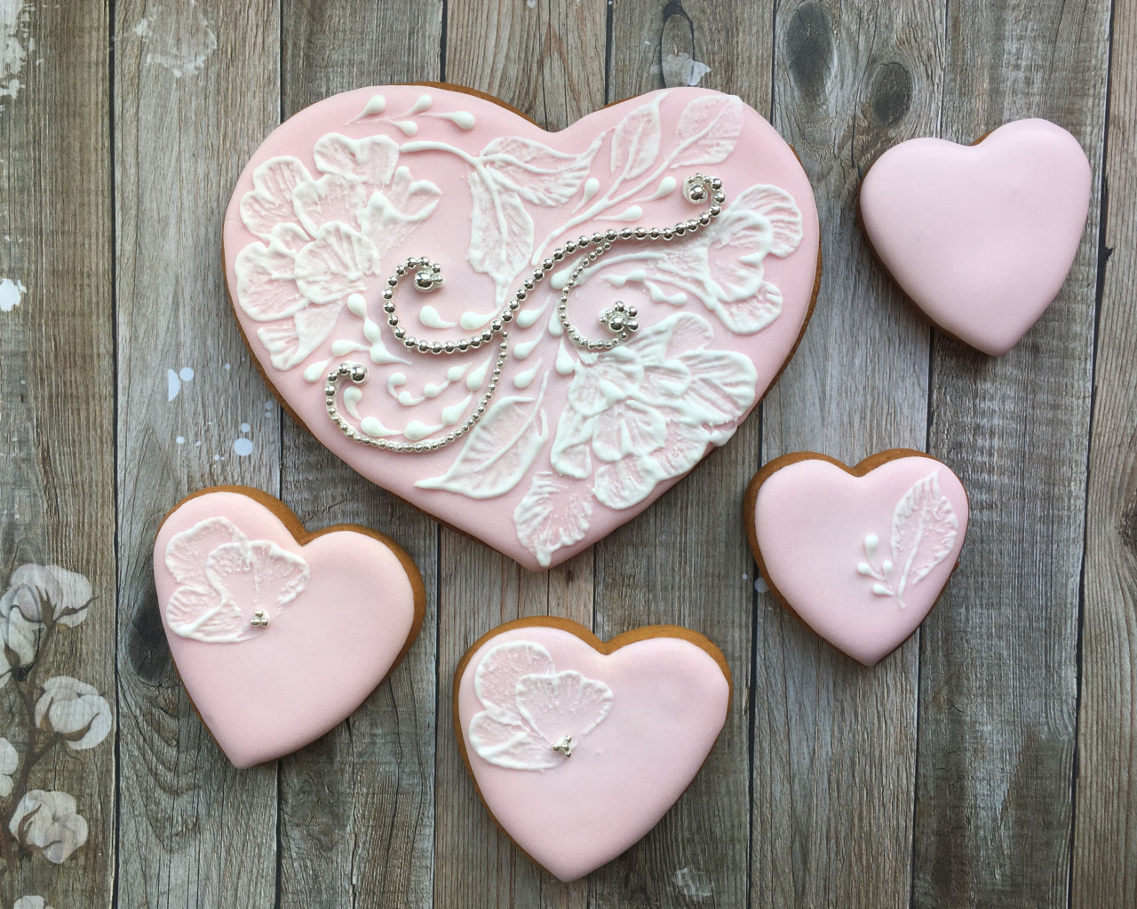 Heart shaped cookies with pink icing on the table