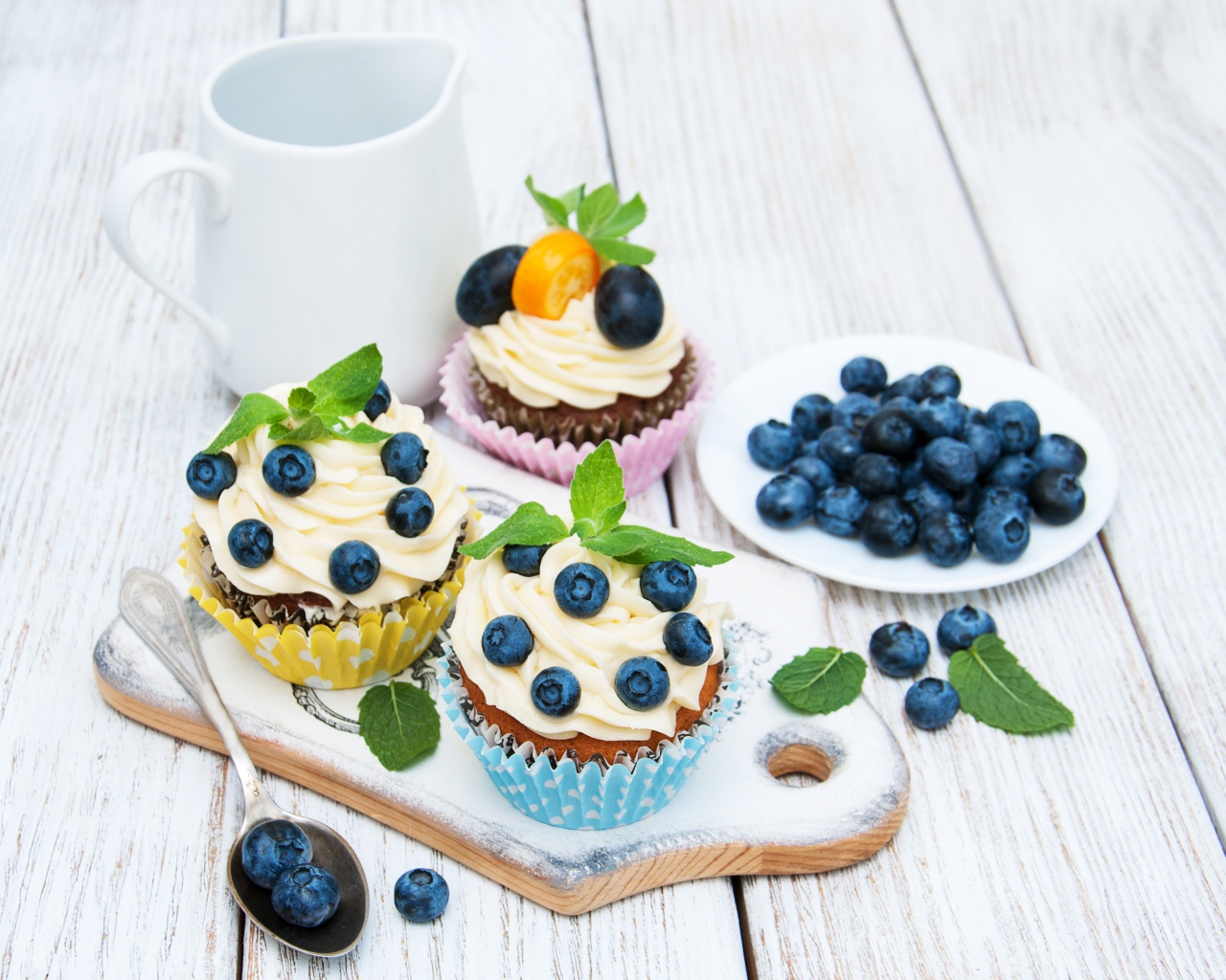Muffins on a table with blueberries