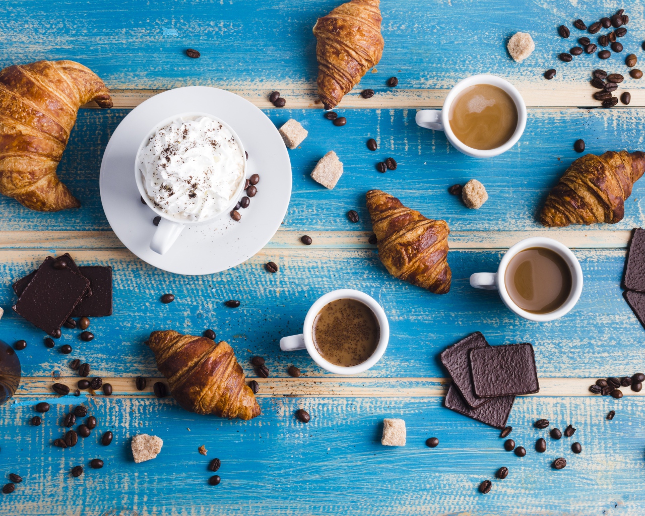 Сладости с кофе на голубом столе