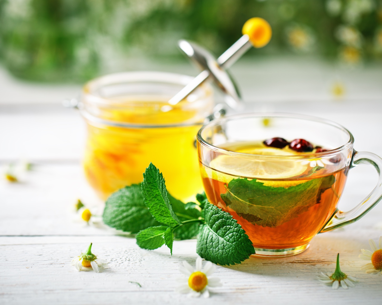 Чашка чая с лимоном и мятой на столе с медом