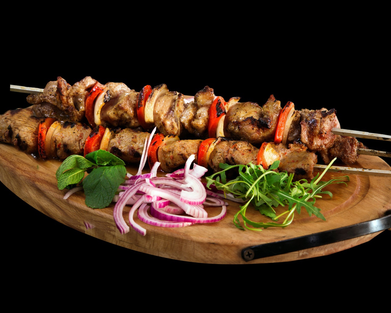 Шашлык на разделочной доске с луком и зеленью 