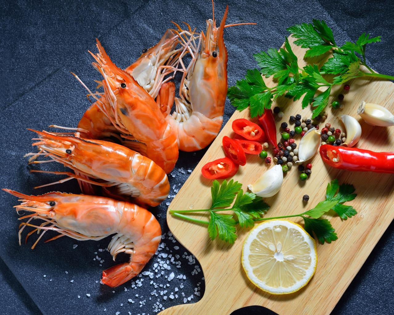 Boiled shrimps on the table with spices and herbs