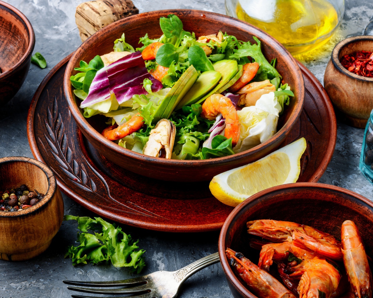Salad with seafood is on the table with spices