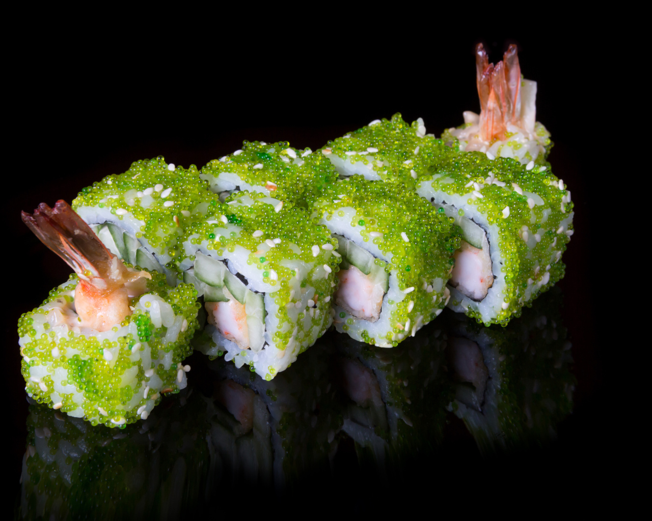 Sushi with caviar and shrimps on a black background