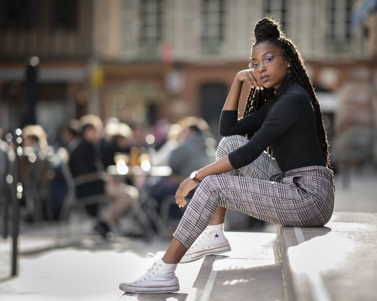 Красивая темнокожая девушка сидит на ступеньках