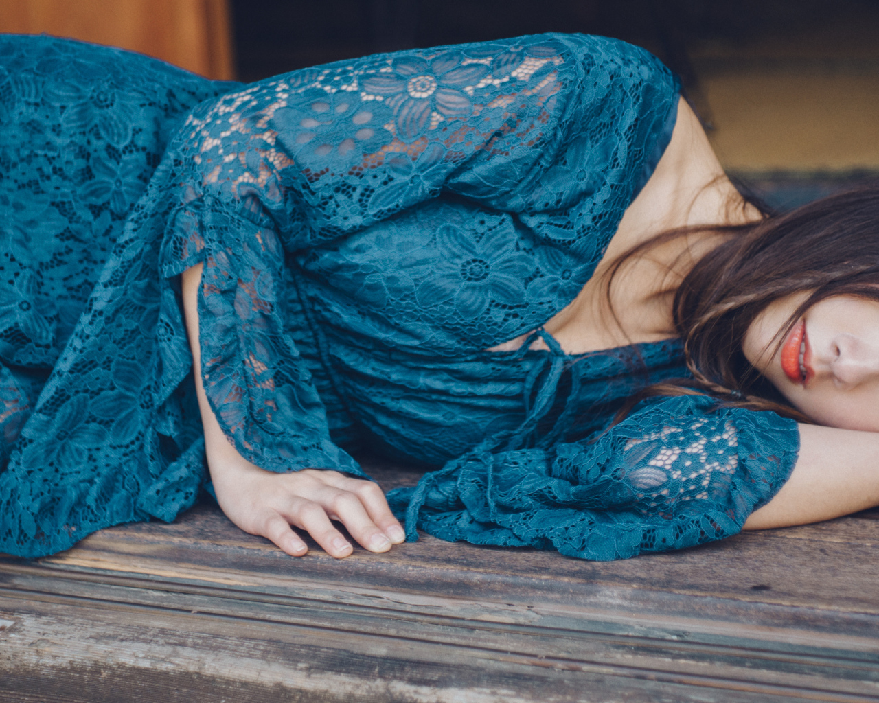 Красивая девушка азиатка в платье лежит на полу