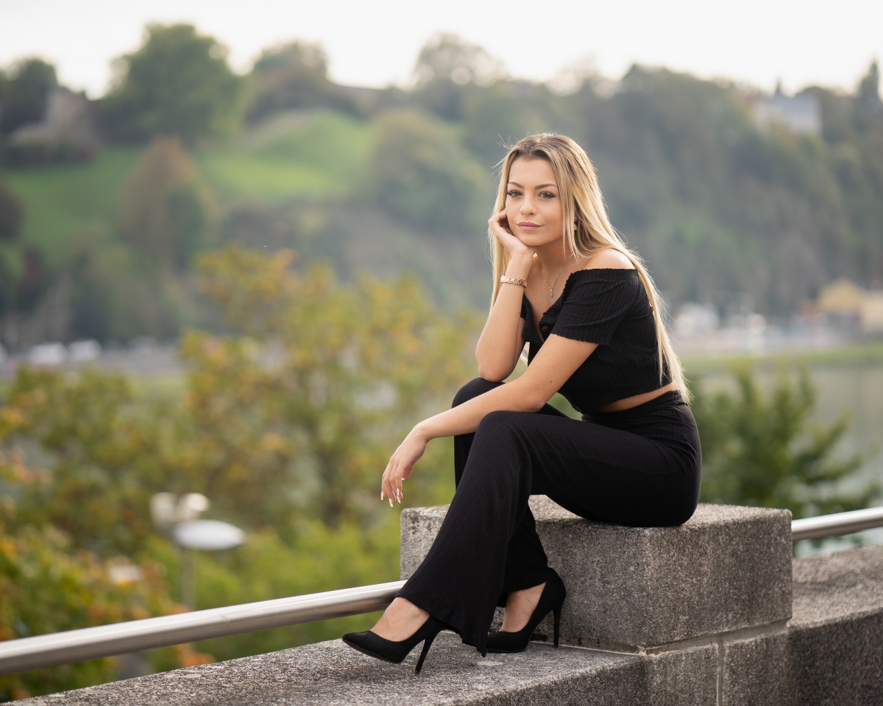 Красивая девушка в черном сидит