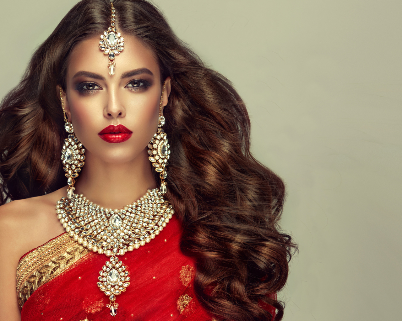 Красивая длинноволосая шатенка в индийском сари с украшениями