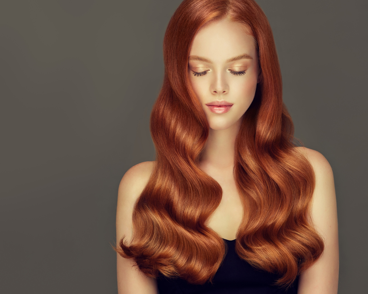 Красивая нежная рыжеволосая девушка на сером фоне