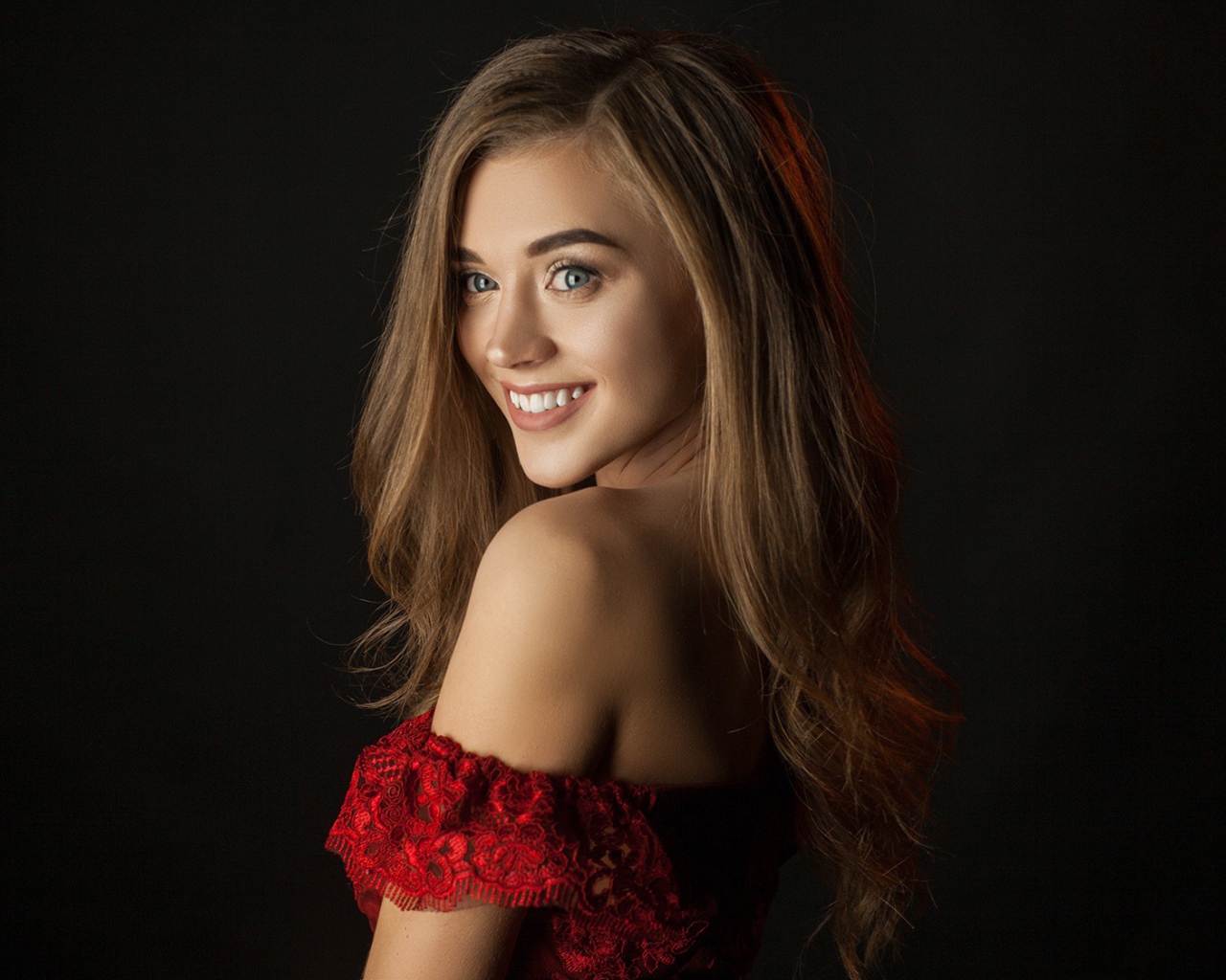 Cute smiling girl on black background