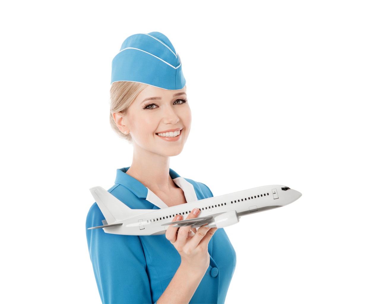 Девушка стюардесса с самолетом в руке на белом фоне
