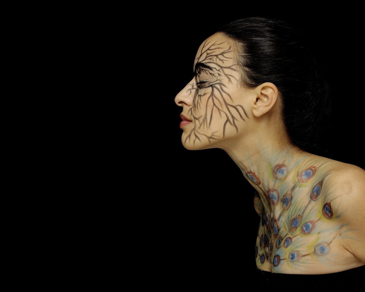 Девушка с рисунками на теле на черном фоне