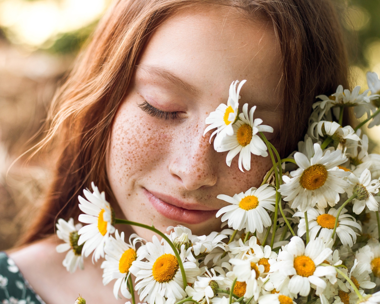 Рыжеволосая девушка с букетом ромашек