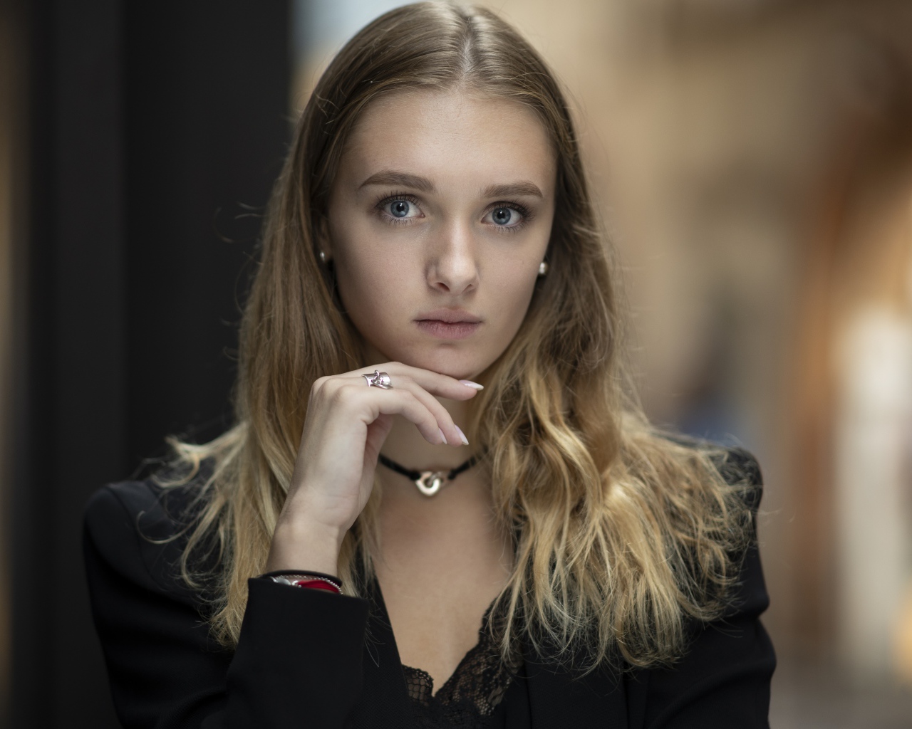 Молодая нежная голубоглазая девушка с рукой у лица