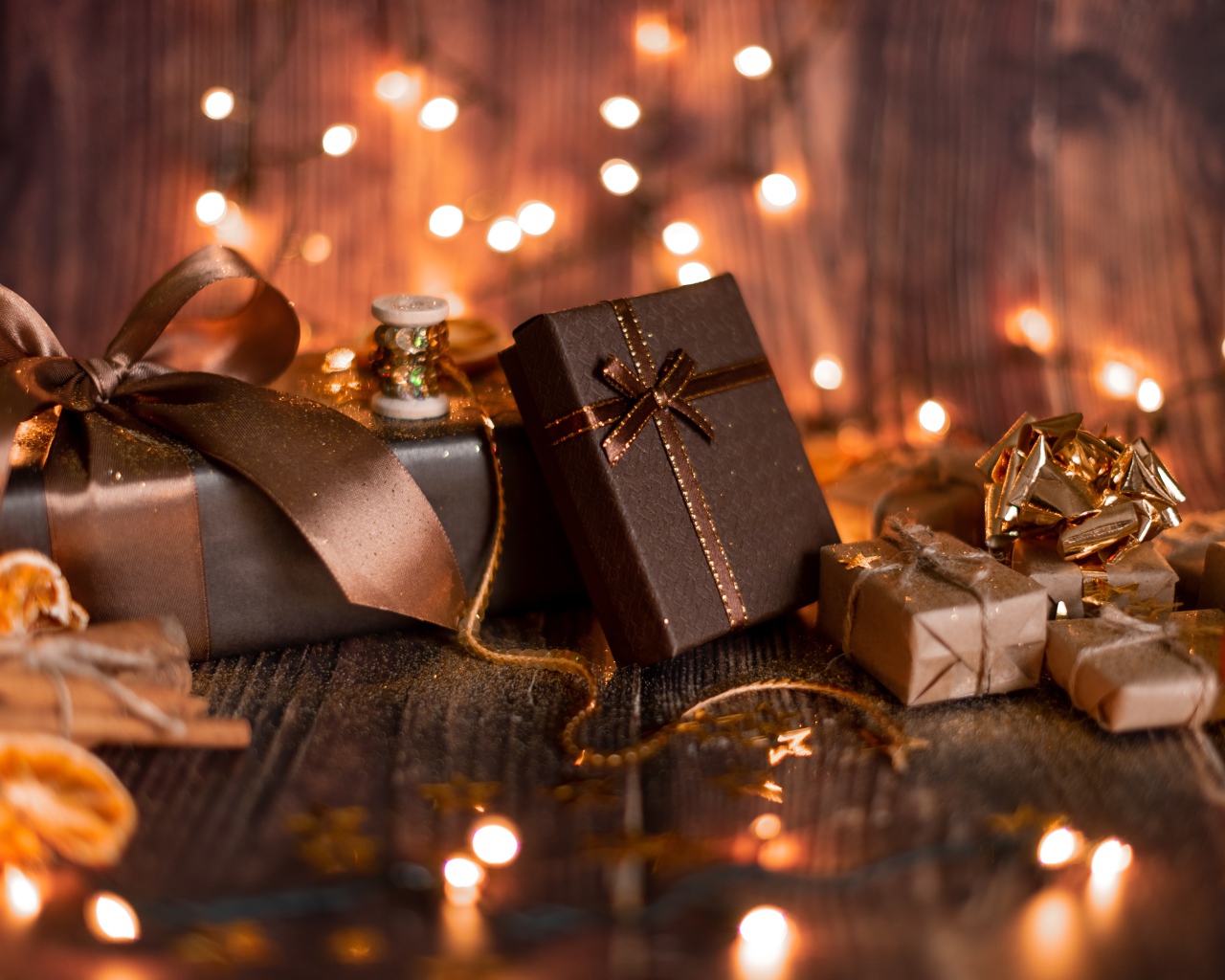 A lot of gifts on a wooden background with a garland
