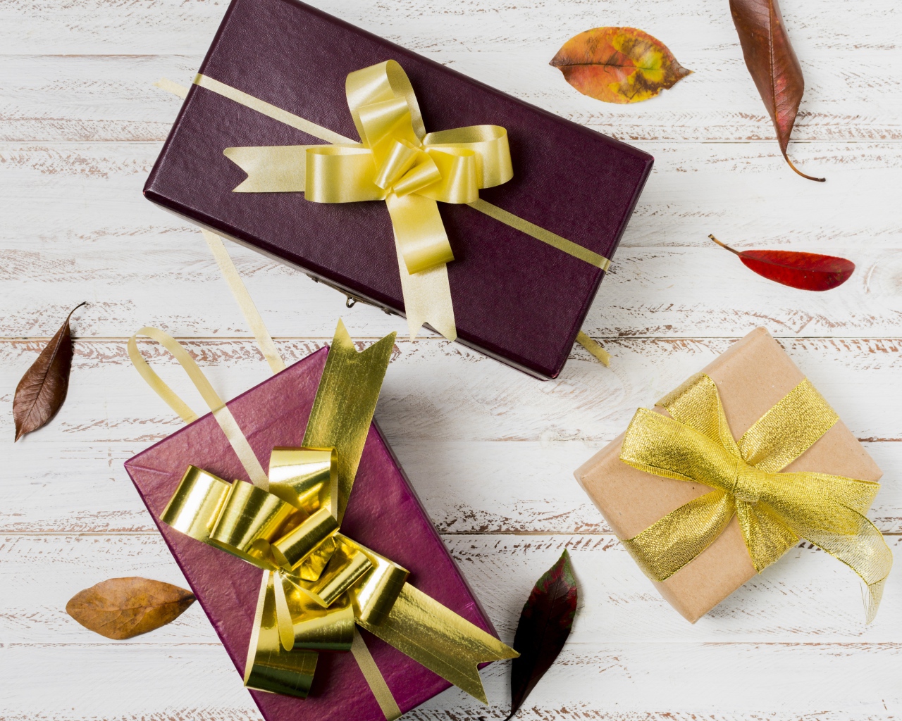 Three gift boxes with bows on the table