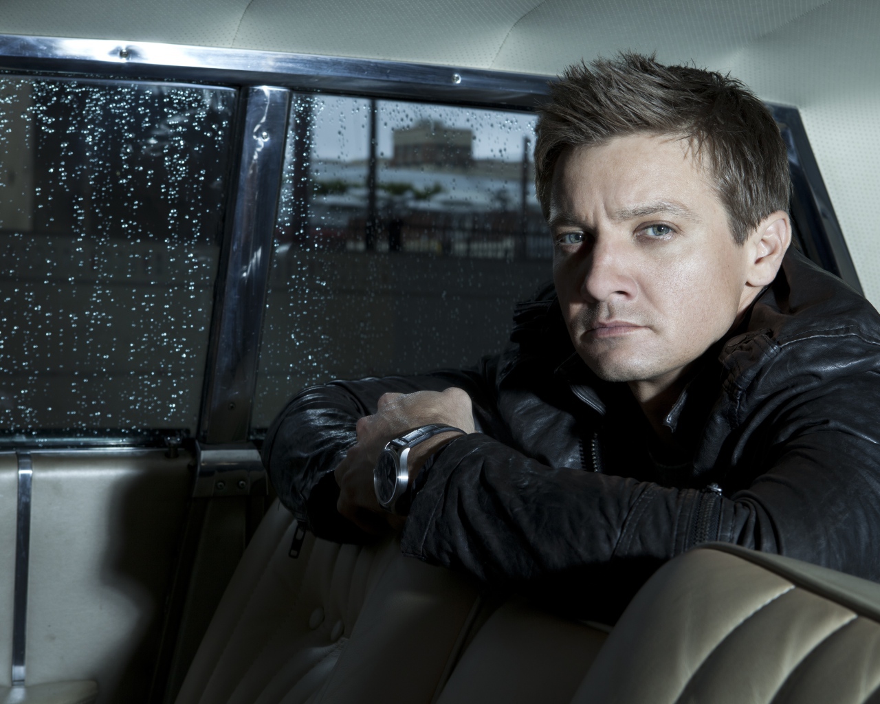 Actor Jeremy Renner is sitting in the car