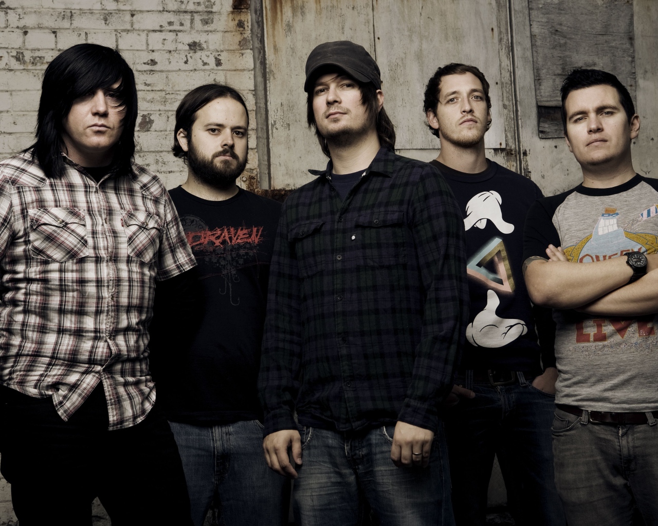 Музыкальная группа Funeral for a Friend стоят у старой стены