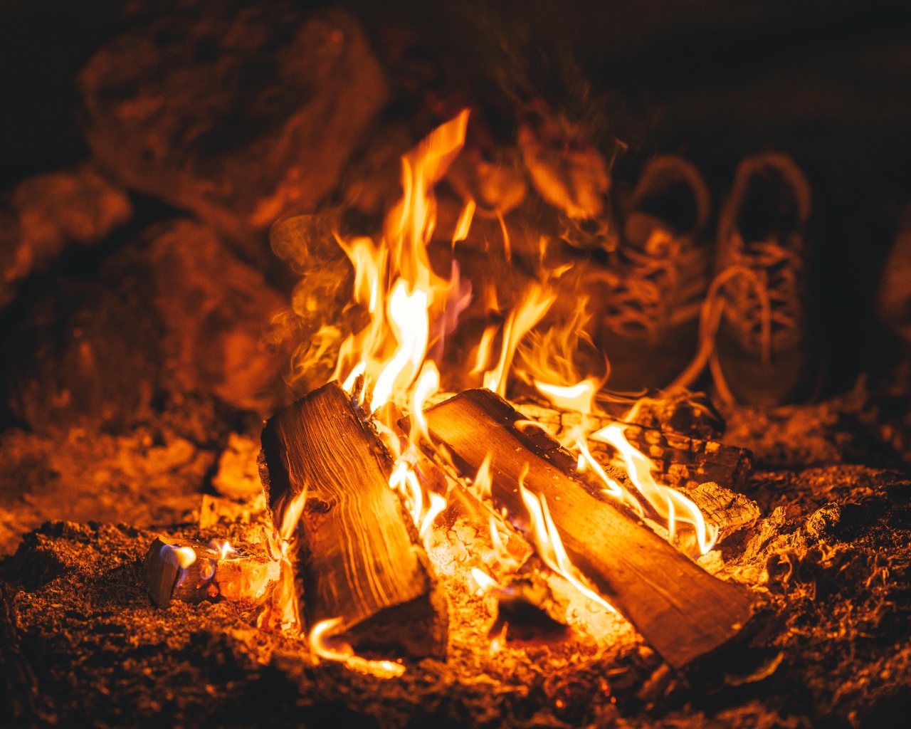 Firewood lies in the bright fire of a fire