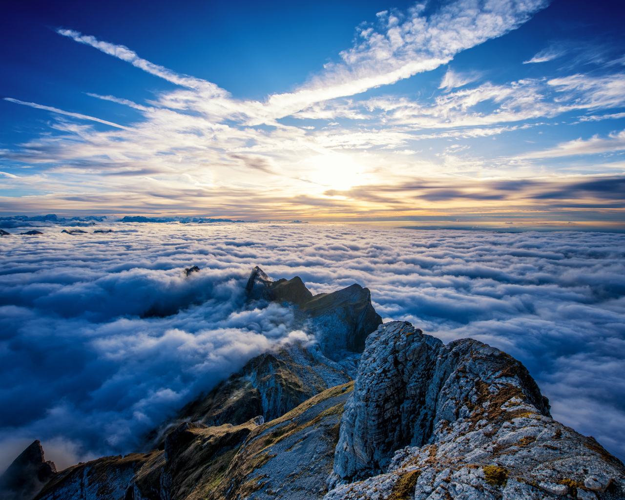 Густые белые облака над вершинами гор на рассвете