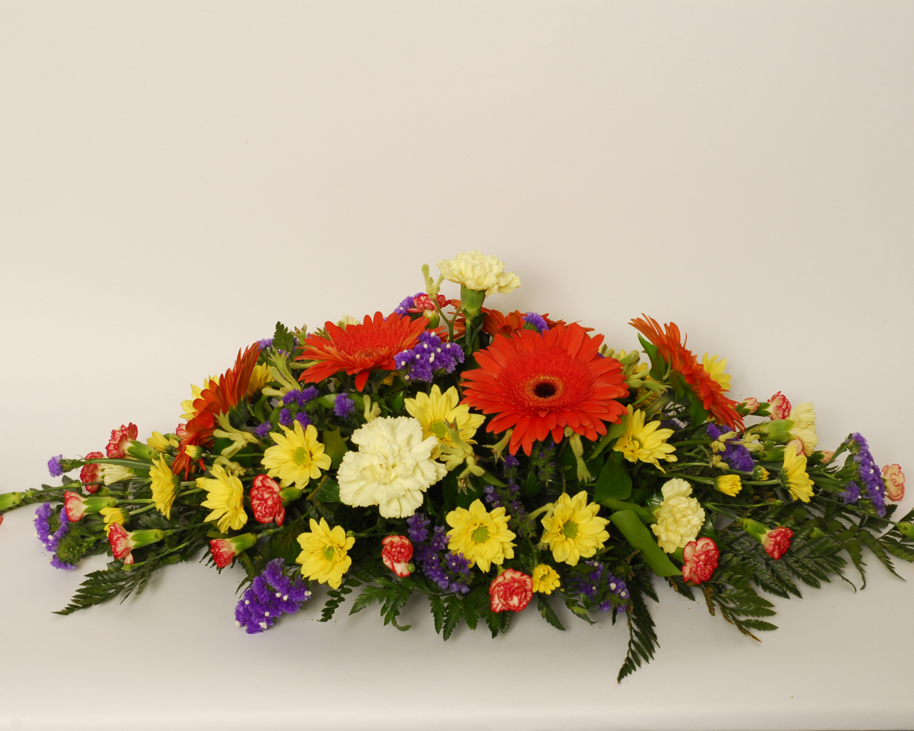 Букет разных разноцветных цветов на сером фоне