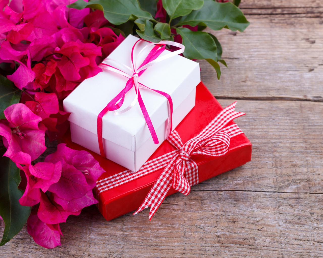 Две коробки с подарками на столе с цветами