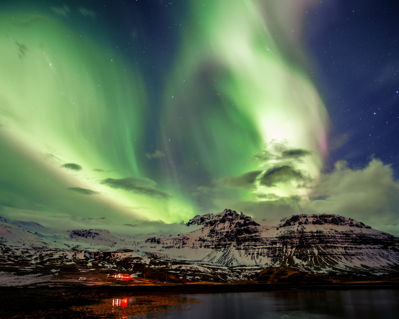 Northern lights over snowy mountains, Iceland