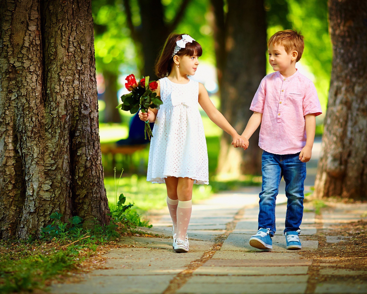 Boy and girl walk in the park