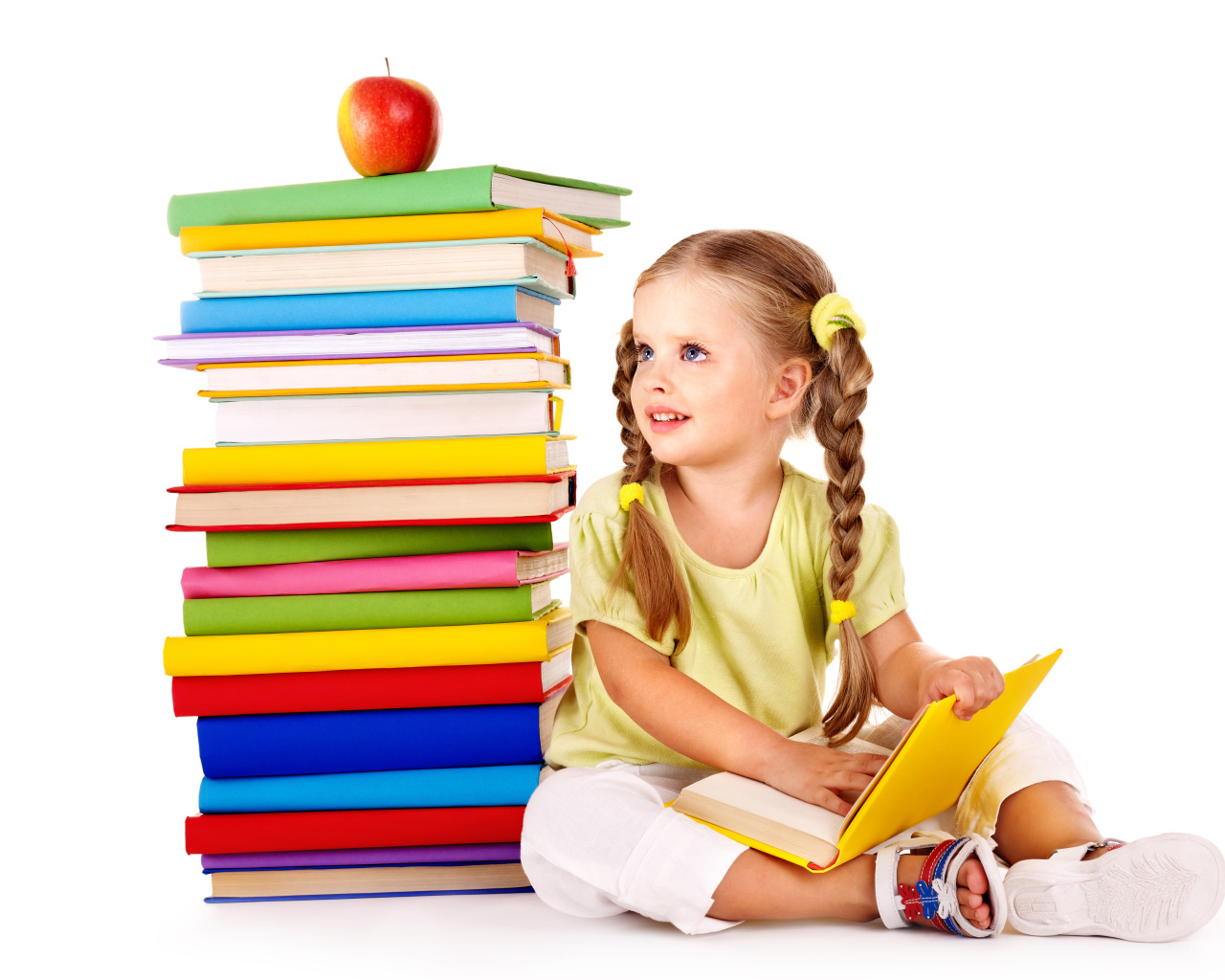 Маленькая девочка школьница с книгами на белом фоне