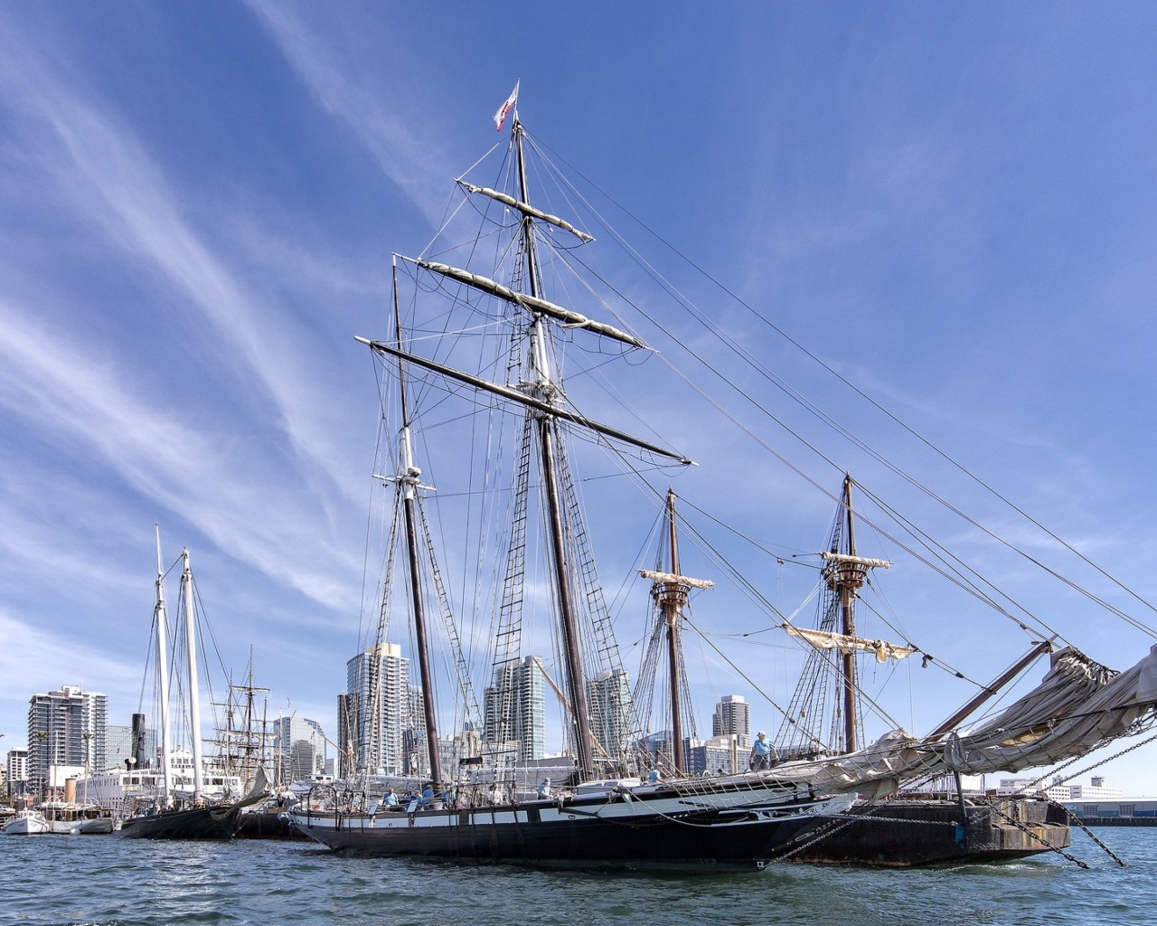 Large sailing boat on a background of blue sky in the port near the city