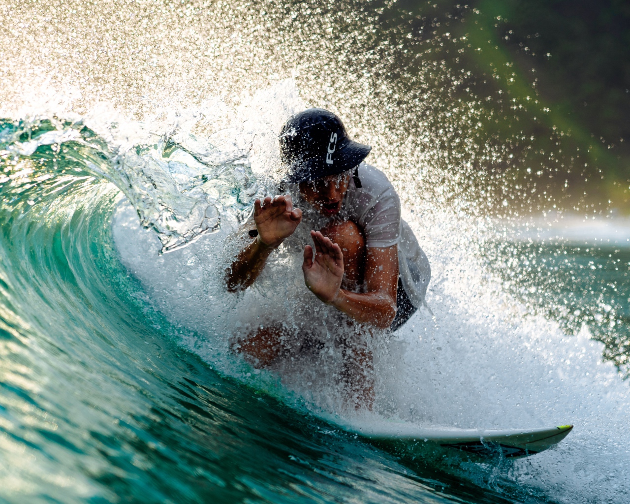 Парень серфингист ловит голубую морскую волну