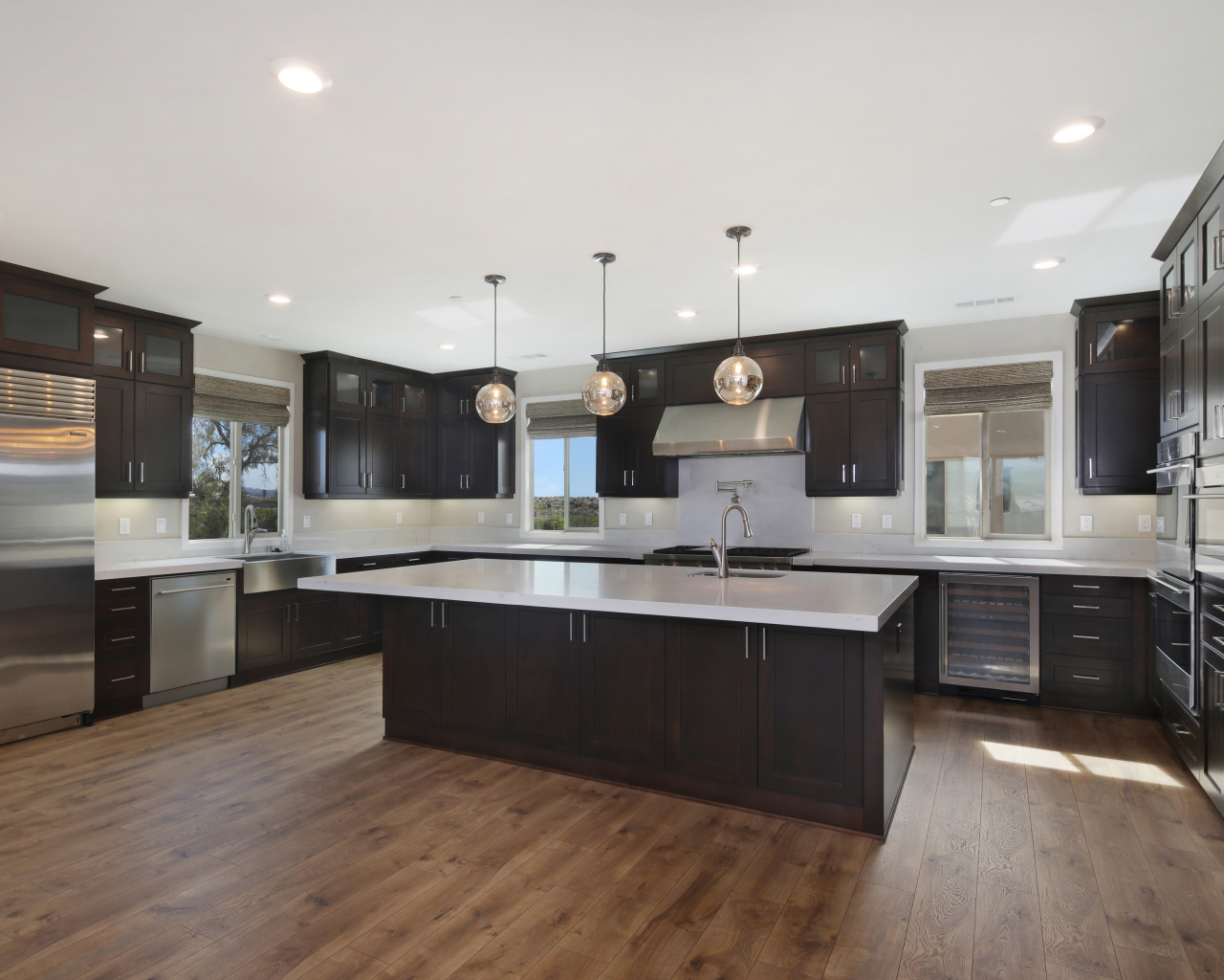 Large spacious kitchen with brown furniture.