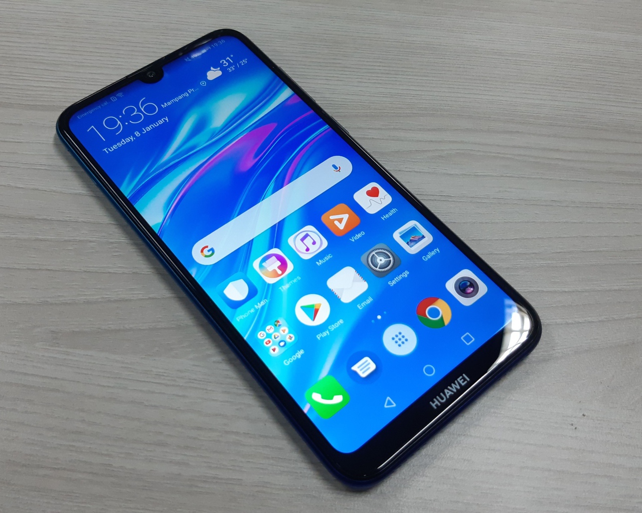 Смартфон Huawei Y7 Pro, 2019 года лежит на деревянном столе