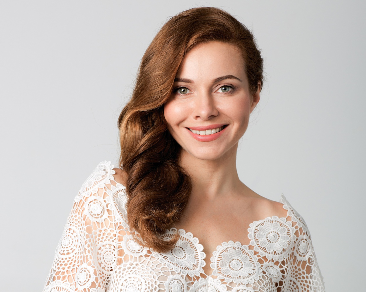 Улыбающаяся милая девушка, актриса Екатерина Гусева на сером фоне