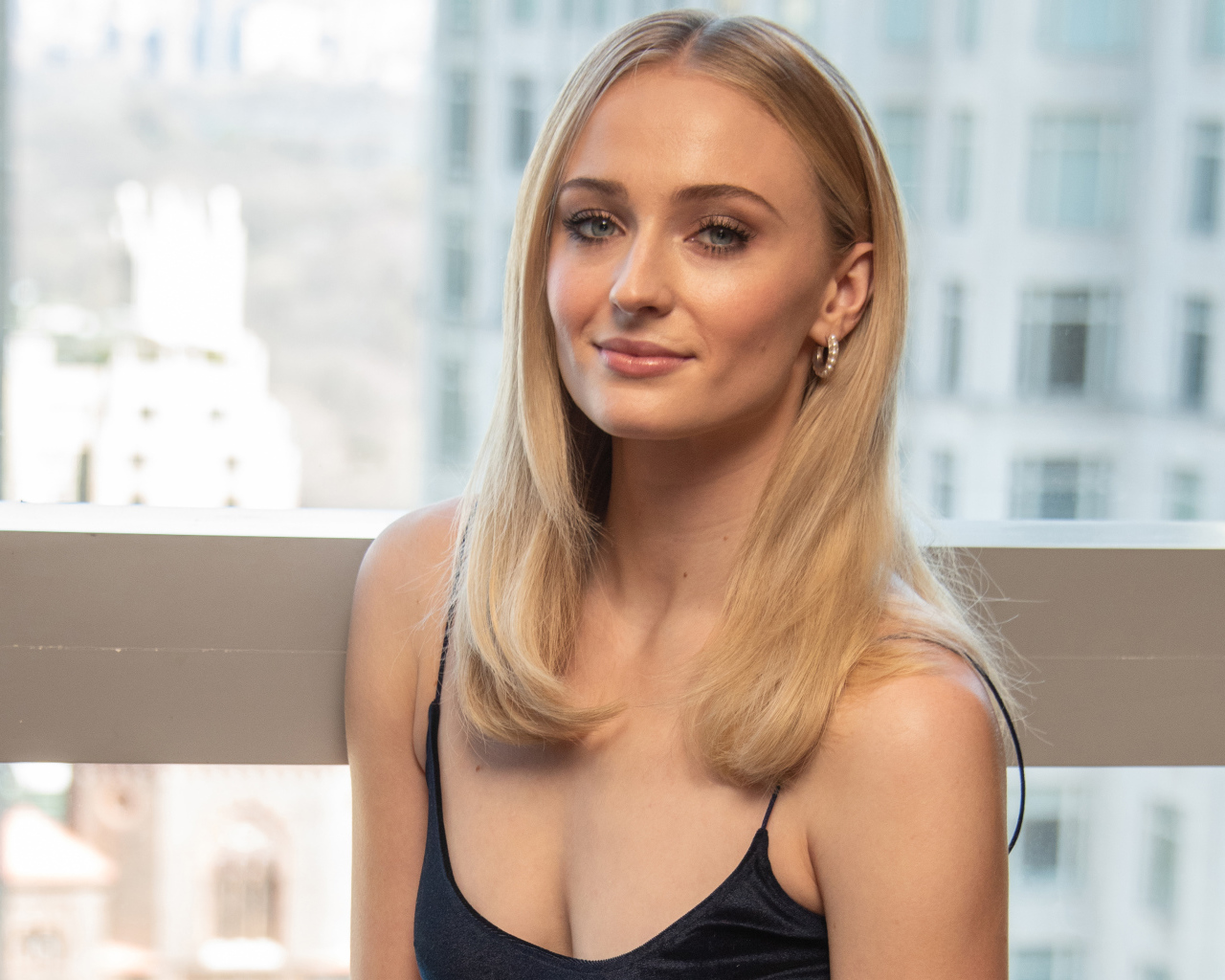 Стильная красивая блондинка, актриса Софи Тёрнер у окна