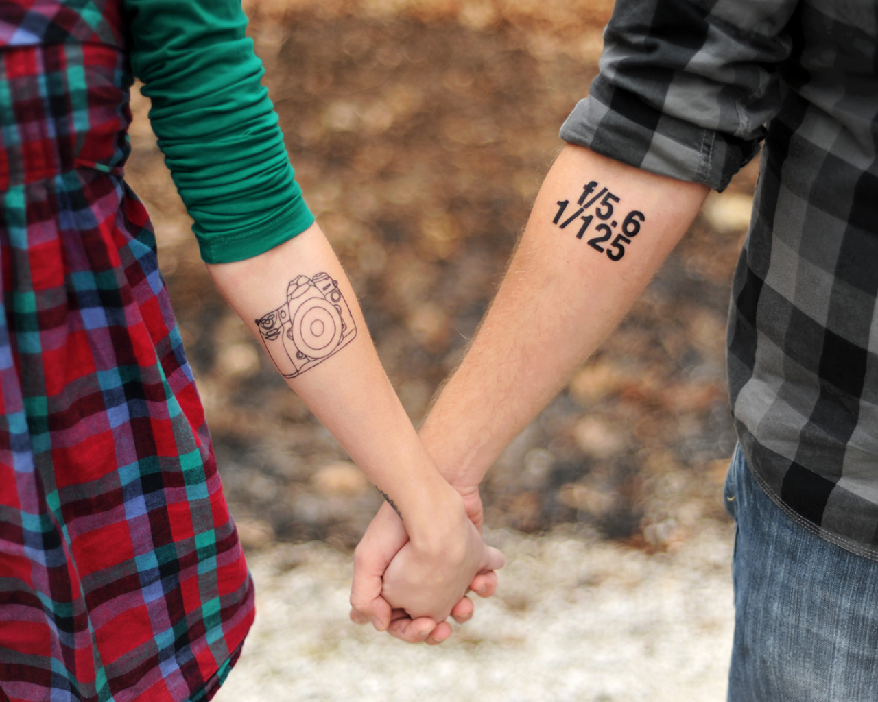 Tattoos on the hands of a couple in love