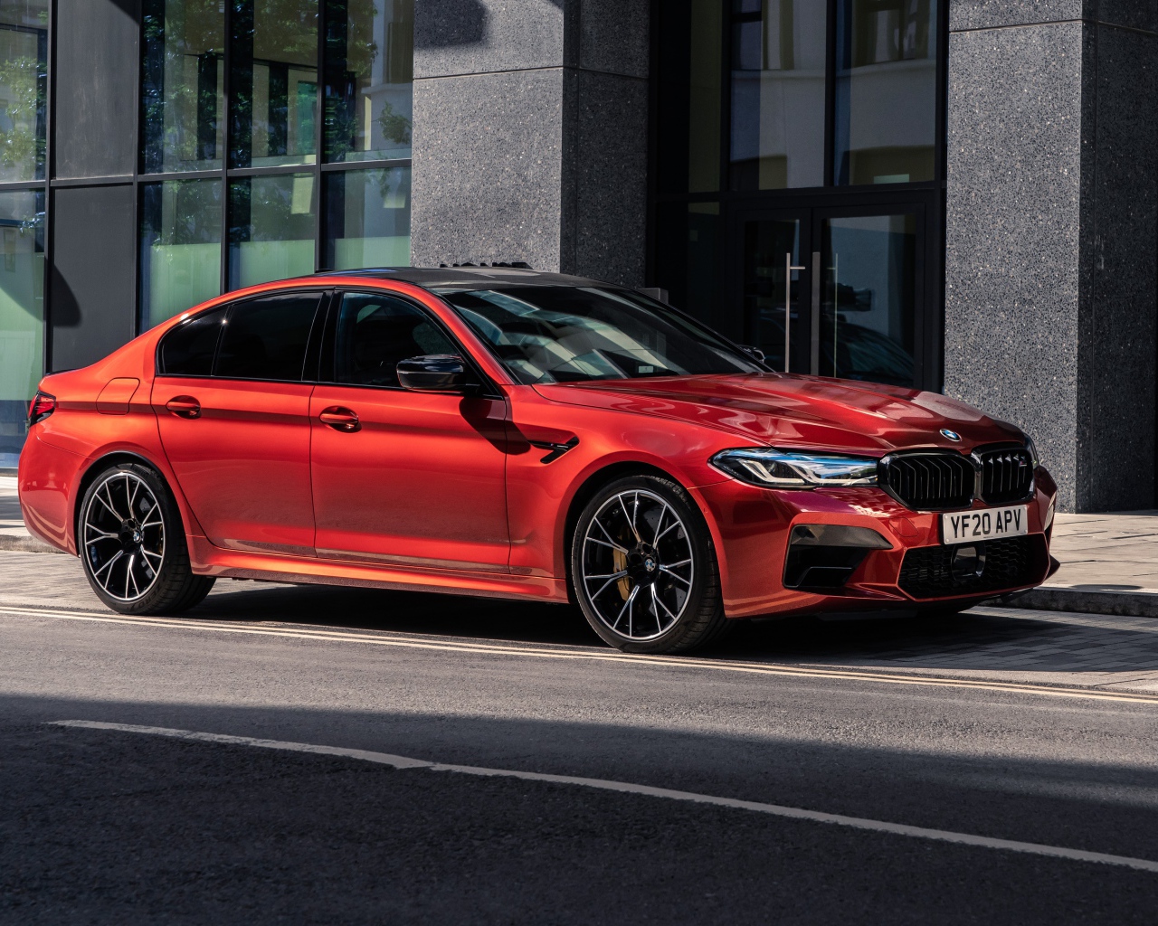 Красный автомобиль BMW M5 Competition 2020 года у дома