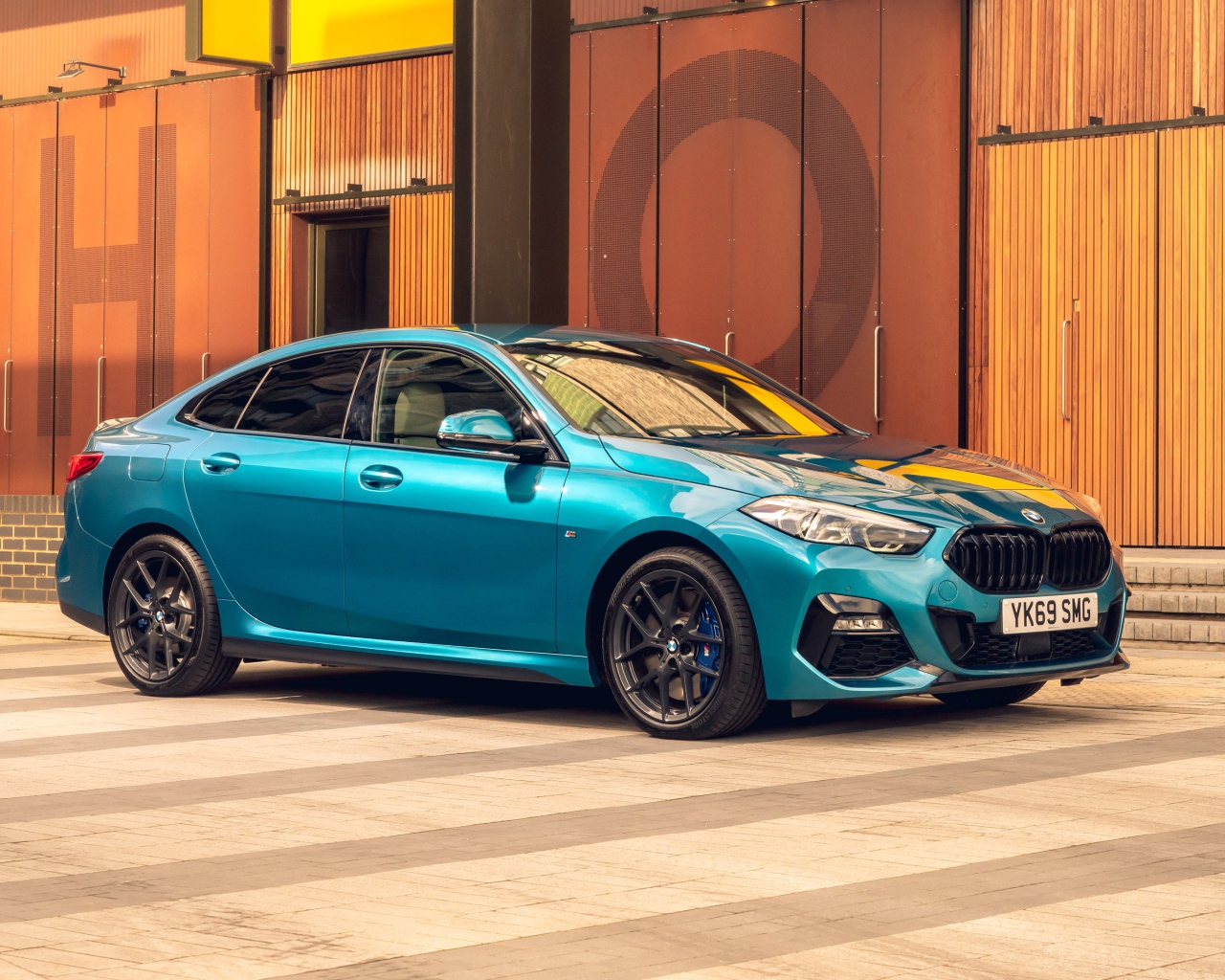 Синий автомобиль BMW 218i Gran Coupe M Sport 2020 года у здания 