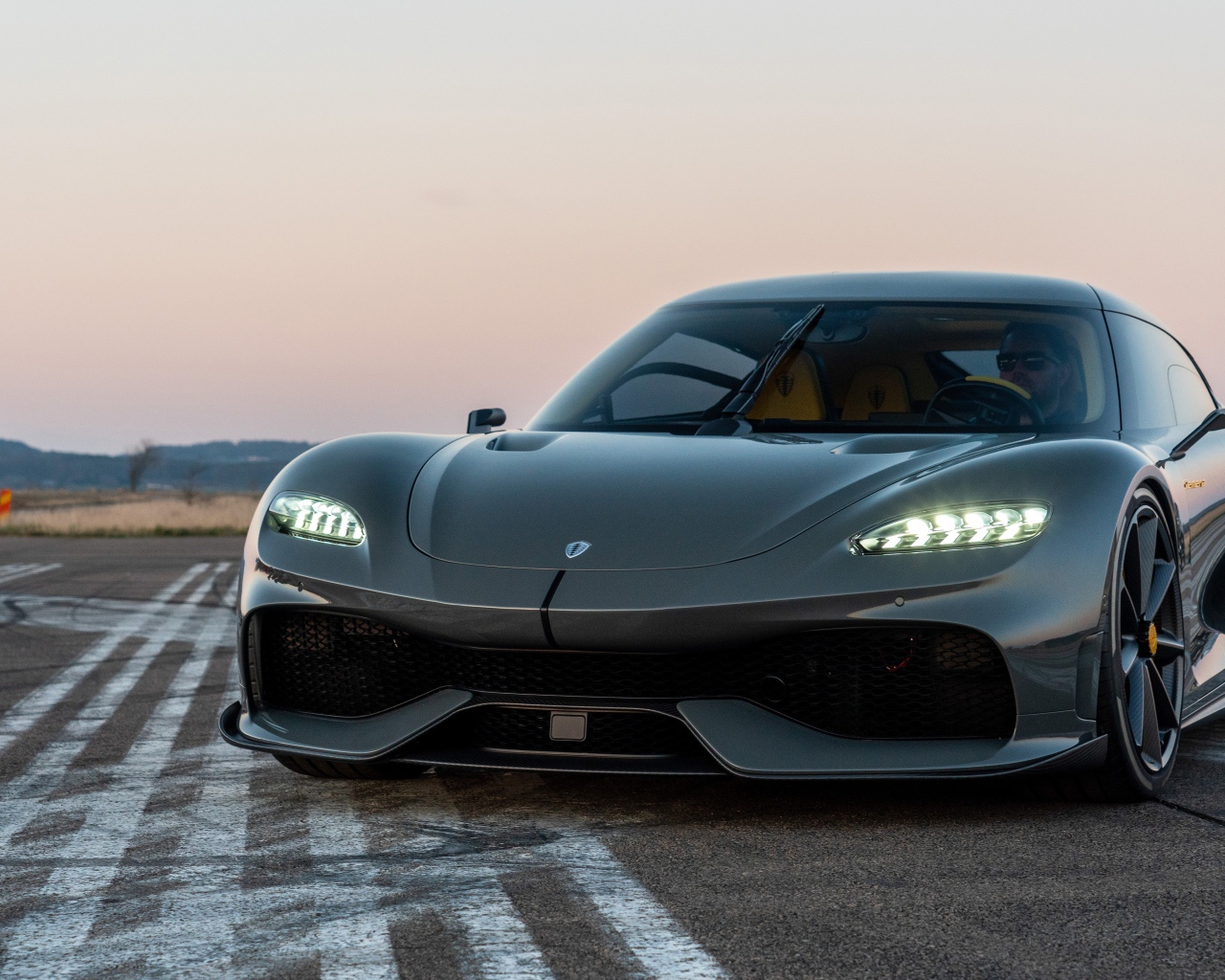 Черный автомобиль Koenigsegg Gemera 2020 года на асфальте 