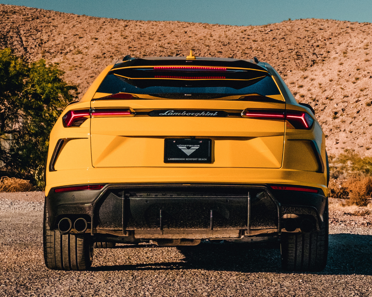Желтый автомобиль Lamborghini Urus 2019 года вид сзади